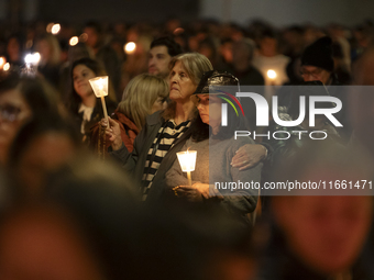 Pilgrims hold candles and pray during the candle procession at the Sanctuary of Fatima, in Fatima, Portugal, on October 12, 2024, on the ann...