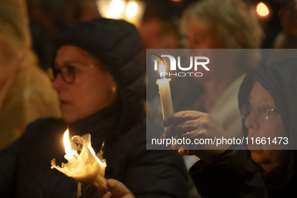 Pilgrims hold candles and pray during the candle procession at the Sanctuary of Fatima, in Fatima, Portugal, on October 12, 2024, on the ann...