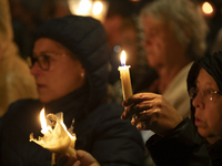 Pilgrims hold candles and pray during the candle procession at the Sanctuary of Fatima, in Fatima, Portugal, on October 12, 2024, on the ann...