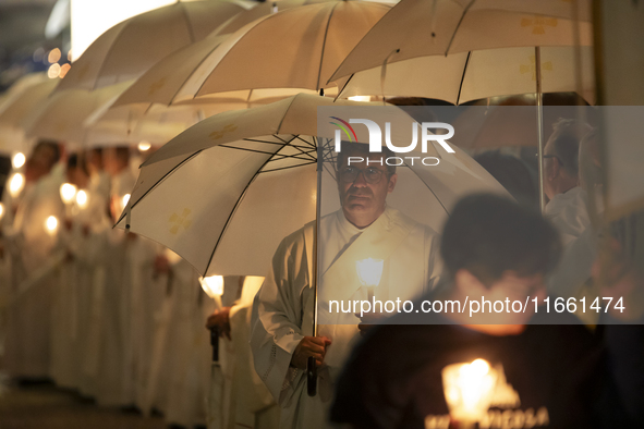 Pilgrims hold candles and pray during the candle procession at the Sanctuary of Fatima, in Fatima, Portugal, on October 12, 2024, on the ann...