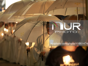 Pilgrims hold candles and pray during the candle procession at the Sanctuary of Fatima, in Fatima, Portugal, on October 12, 2024, on the ann...