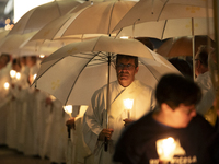 Pilgrims hold candles and pray during the candle procession at the Sanctuary of Fatima, in Fatima, Portugal, on October 12, 2024, on the ann...