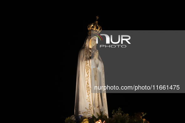 Pilgrims hold candles and pray during the candle procession at the Sanctuary of Fatima, in Fatima, Portugal, on October 12, 2024, on the ann...