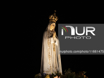 Pilgrims hold candles and pray during the candle procession at the Sanctuary of Fatima, in Fatima, Portugal, on October 12, 2024, on the ann...