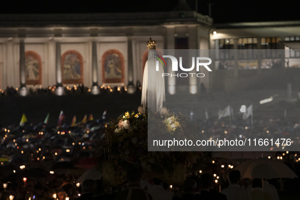 Pilgrims hold candles and pray during the candle procession at the Sanctuary of Fatima, in Fatima, Portugal, on October 12, 2024, on the ann...