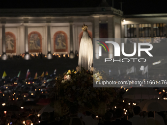 Pilgrims hold candles and pray during the candle procession at the Sanctuary of Fatima, in Fatima, Portugal, on October 12, 2024, on the ann...