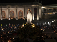 Pilgrims hold candles and pray during the candle procession at the Sanctuary of Fatima, in Fatima, Portugal, on October 12, 2024, on the ann...