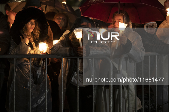 Pilgrims hold candles and pray during the candle procession at the Sanctuary of Fatima, in Fatima, Portugal, on October 12, 2024, on the ann...