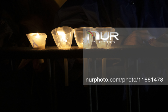 Pilgrims hold candles and pray during the candle procession at the Sanctuary of Fatima, in Fatima, Portugal, on October 12, 2024, on the ann...