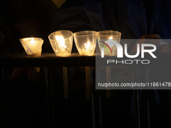 Pilgrims hold candles and pray during the candle procession at the Sanctuary of Fatima, in Fatima, Portugal, on October 12, 2024, on the ann...