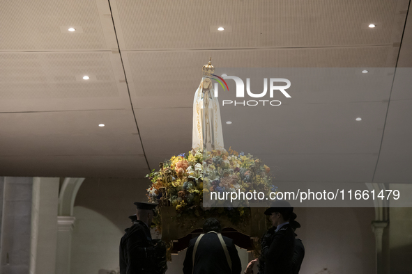 Pilgrims hold candles and pray during the candle procession at the Sanctuary of Fatima, in Fatima, Portugal, on October 12, 2024, on the ann...