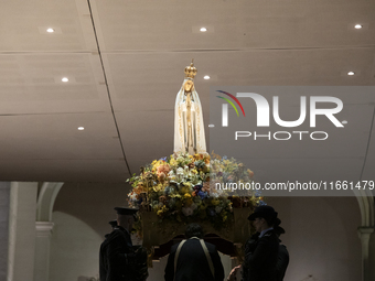 Pilgrims hold candles and pray during the candle procession at the Sanctuary of Fatima, in Fatima, Portugal, on October 12, 2024, on the ann...