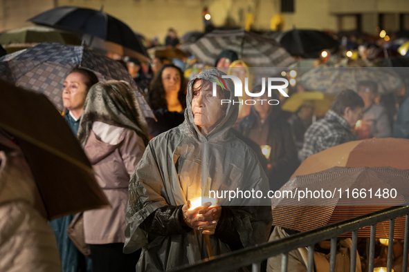 Pilgrims hold candles and pray during the candle procession at the Sanctuary of Fatima, in Fatima, Portugal, on October 12, 2024, on the ann...