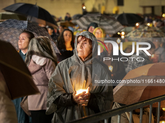 Pilgrims hold candles and pray during the candle procession at the Sanctuary of Fatima, in Fatima, Portugal, on October 12, 2024, on the ann...