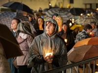 Pilgrims hold candles and pray during the candle procession at the Sanctuary of Fatima, in Fatima, Portugal, on October 12, 2024, on the ann...