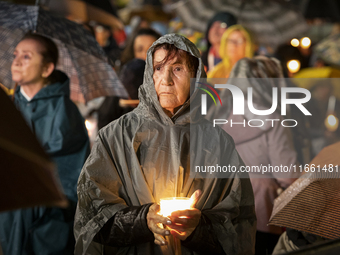 Pilgrims hold candles and pray during the candle procession at the Sanctuary of Fatima, in Fatima, Portugal, on October 12, 2024, on the ann...