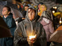 Pilgrims hold candles and pray during the candle procession at the Sanctuary of Fatima, in Fatima, Portugal, on October 12, 2024, on the ann...