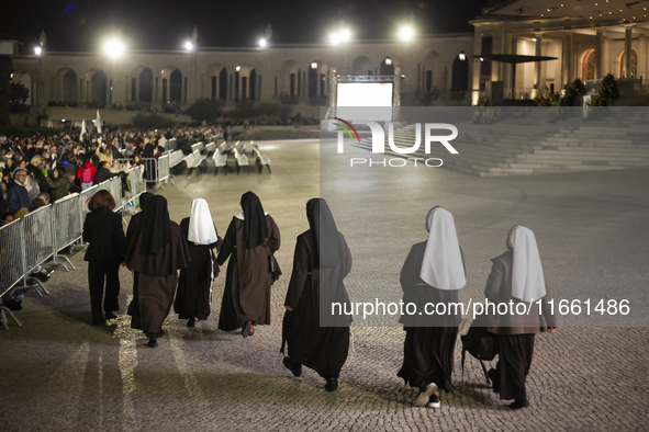 Pilgrims hold candles and pray during the candle procession at the Sanctuary of Fatima, in Fatima, Portugal, on October 12, 2024, on the ann...