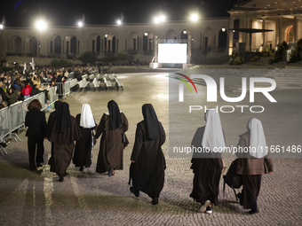 Pilgrims hold candles and pray during the candle procession at the Sanctuary of Fatima, in Fatima, Portugal, on October 12, 2024, on the ann...