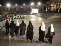 Pilgrims hold candles and pray during the candle procession at the Sanctuary of Fatima, in Fatima, Portugal, on October 12, 2024, on the ann...