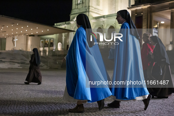 Pilgrims hold candles and pray during the candle procession at the Sanctuary of Fatima, in Fatima, Portugal, on October 12, 2024, on the ann...