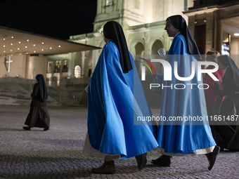 Pilgrims hold candles and pray during the candle procession at the Sanctuary of Fatima, in Fatima, Portugal, on October 12, 2024, on the ann...