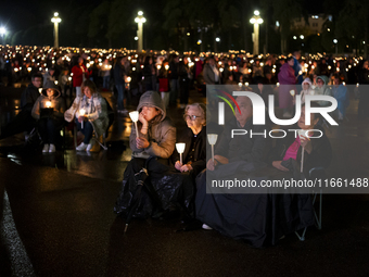 Pilgrims hold candles and pray during the candle procession at the Sanctuary of Fatima, in Fatima, Portugal, on October 12, 2024, on the ann...