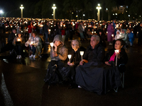 Pilgrims hold candles and pray during the candle procession at the Sanctuary of Fatima, in Fatima, Portugal, on October 12, 2024, on the ann...