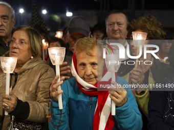 Pilgrims hold candles and pray during the candle procession at the Sanctuary of Fatima, in Fatima, Portugal, on October 12, 2024, on the ann...