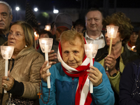 Pilgrims hold candles and pray during the candle procession at the Sanctuary of Fatima, in Fatima, Portugal, on October 12, 2024, on the ann...