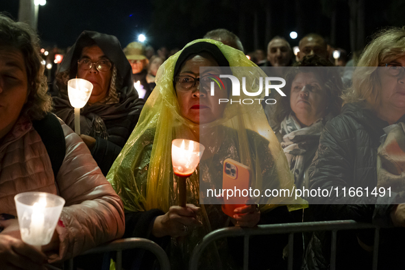 Pilgrims hold candles and pray during the candle procession at the Sanctuary of Fatima, in Fatima, Portugal, on October 12, 2024, on the ann...