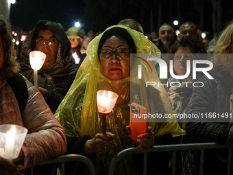 Pilgrims hold candles and pray during the candle procession at the Sanctuary of Fatima, in Fatima, Portugal, on October 12, 2024, on the ann...