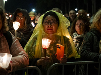 Pilgrims hold candles and pray during the candle procession at the Sanctuary of Fatima, in Fatima, Portugal, on October 12, 2024, on the ann...