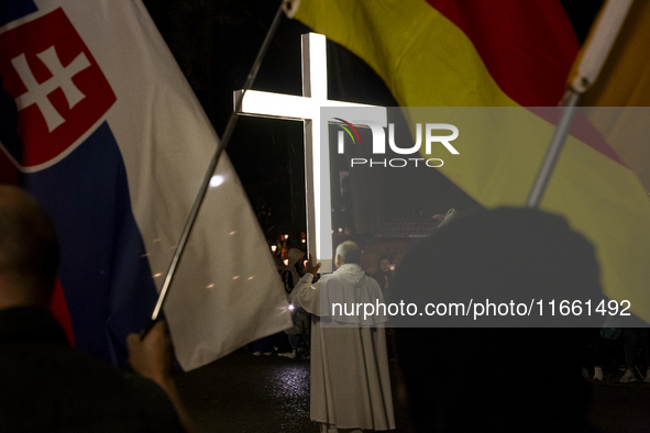 Pilgrims hold candles and pray during the candle procession at the Sanctuary of Fatima, in Fatima, Portugal, on October 12, 2024, on the ann...