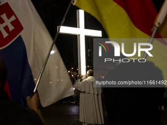 Pilgrims hold candles and pray during the candle procession at the Sanctuary of Fatima, in Fatima, Portugal, on October 12, 2024, on the ann...