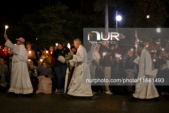 Pilgrims hold candles and pray during the candle procession at the Sanctuary of Fatima, in Fatima, Portugal, on October 12, 2024, on the ann...