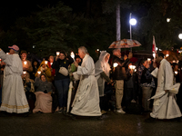 Pilgrims hold candles and pray during the candle procession at the Sanctuary of Fatima, in Fatima, Portugal, on October 12, 2024, on the ann...