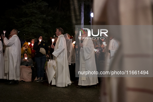 Pilgrims hold candles and pray during the candle procession at the Sanctuary of Fatima, in Fatima, Portugal, on October 12, 2024, on the ann...