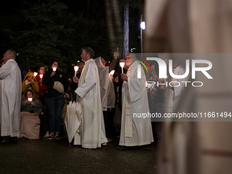 Pilgrims hold candles and pray during the candle procession at the Sanctuary of Fatima, in Fatima, Portugal, on October 12, 2024, on the ann...