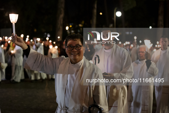 Pilgrims hold candles and pray during the candle procession at the Sanctuary of Fatima, in Fatima, Portugal, on October 12, 2024, on the ann...