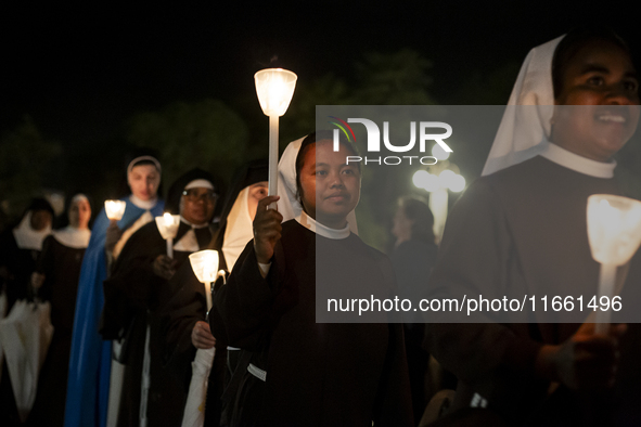 Pilgrims hold candles and pray during the candle procession at the Sanctuary of Fatima, in Fatima, Portugal, on October 12, 2024, on the ann...