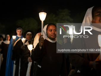 Pilgrims hold candles and pray during the candle procession at the Sanctuary of Fatima, in Fatima, Portugal, on October 12, 2024, on the ann...