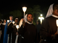 Pilgrims hold candles and pray during the candle procession at the Sanctuary of Fatima, in Fatima, Portugal, on October 12, 2024, on the ann...