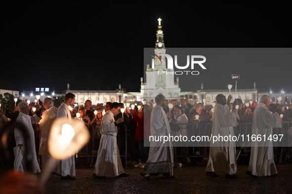 Pilgrims hold candles and pray during the candle procession at the Sanctuary of Fatima, in Fatima, Portugal, on October 12, 2024, on the ann...