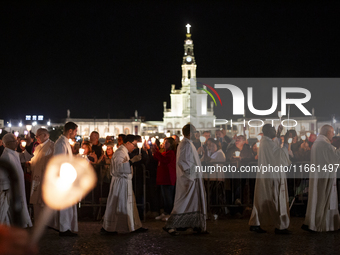 Pilgrims hold candles and pray during the candle procession at the Sanctuary of Fatima, in Fatima, Portugal, on October 12, 2024, on the ann...