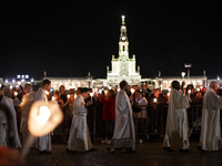 Pilgrims hold candles and pray during the candle procession at the Sanctuary of Fatima, in Fatima, Portugal, on October 12, 2024, on the ann...