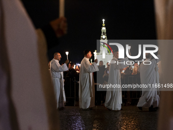 Pilgrims hold candles and pray during the candle procession at the Sanctuary of Fatima, in Fatima, Portugal, on October 12, 2024, on the ann...