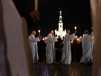 Pilgrims hold candles and pray during the candle procession at the Sanctuary of Fatima, in Fatima, Portugal, on October 12, 2024, on the ann...