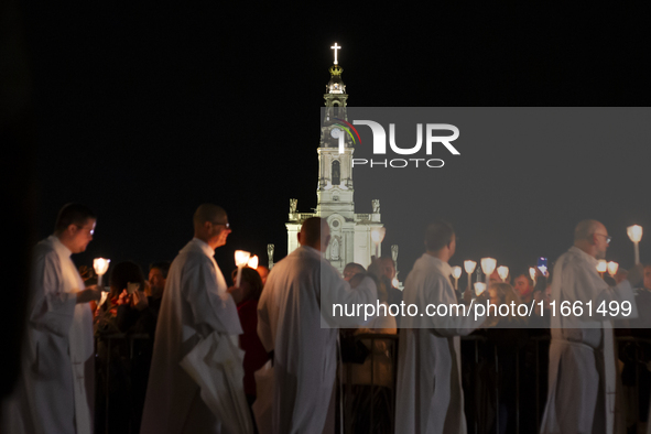 Pilgrims hold candles and pray during the candle procession at the Sanctuary of Fatima, in Fatima, Portugal, on October 12, 2024, on the ann...