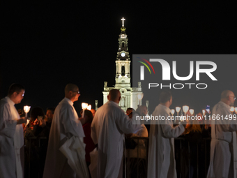 Pilgrims hold candles and pray during the candle procession at the Sanctuary of Fatima, in Fatima, Portugal, on October 12, 2024, on the ann...